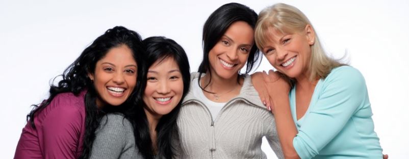 four adult women smiling