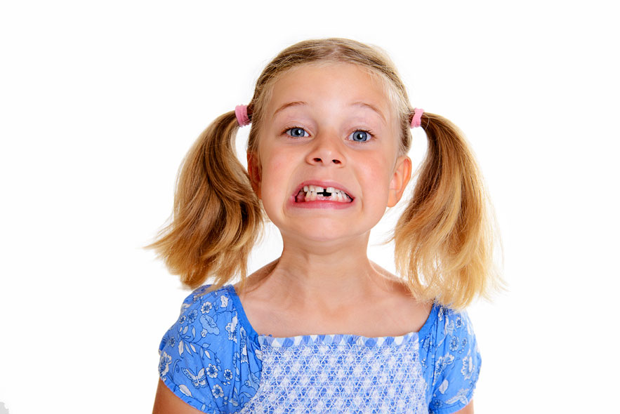 young girl with pigtails missing teeth